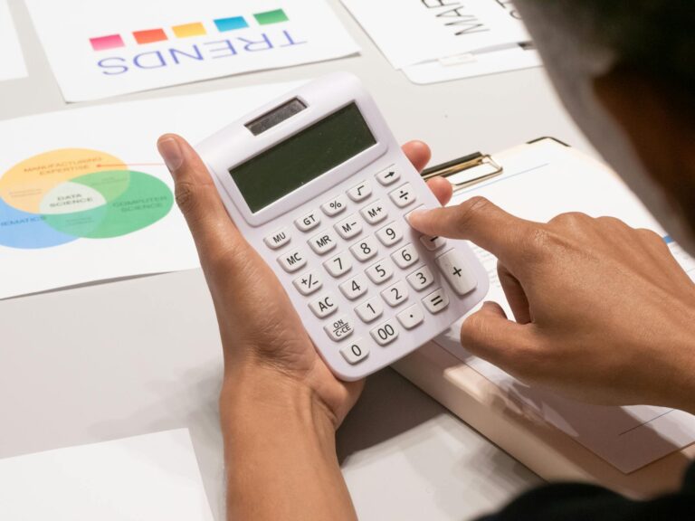 Close-Up Shot of a Person Using Calculator